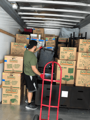 Professional movers loading furniture into a moving truck